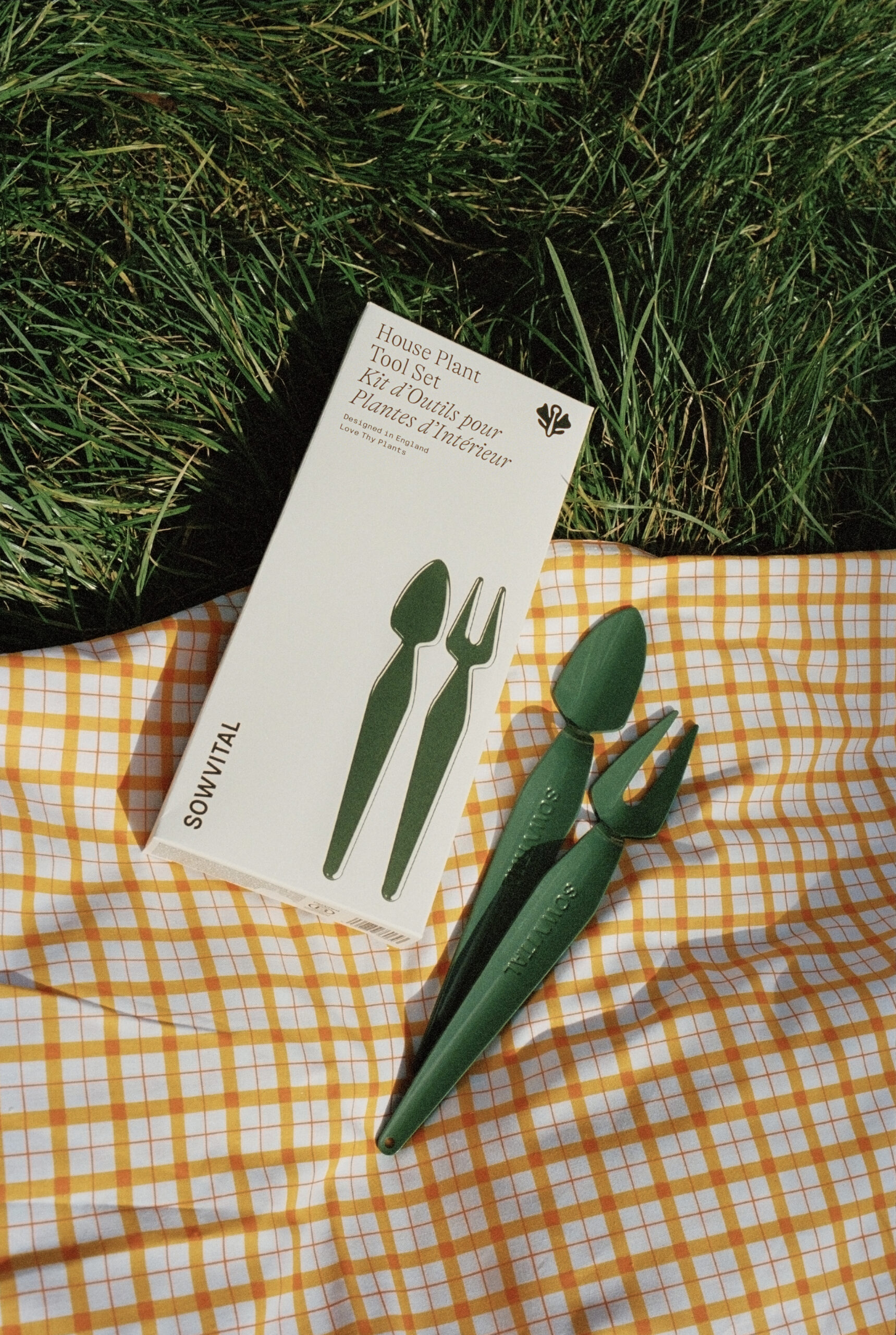 Product images shot from outdoors in Paris. house plant tool set duo in grass