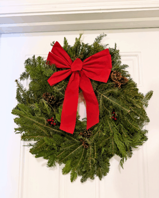 festive nordic mix wreath hanging on door