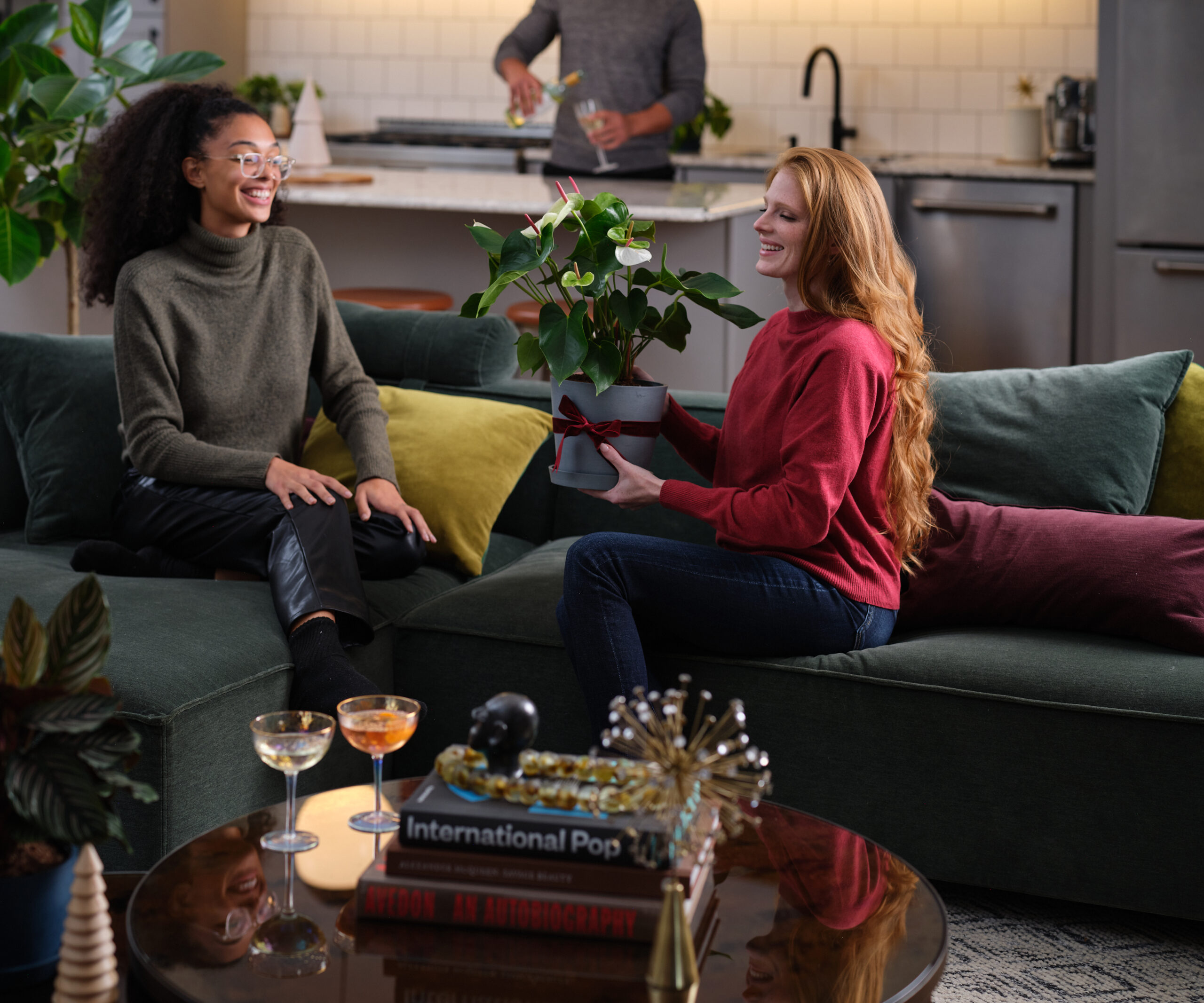 woman gifting a white anthurium to a friend